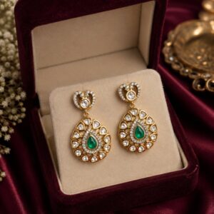 VELQORR Liora emerald heart drop earrings featuring premium kundan stones, emerald green centerpiece, and gold-plated finish.