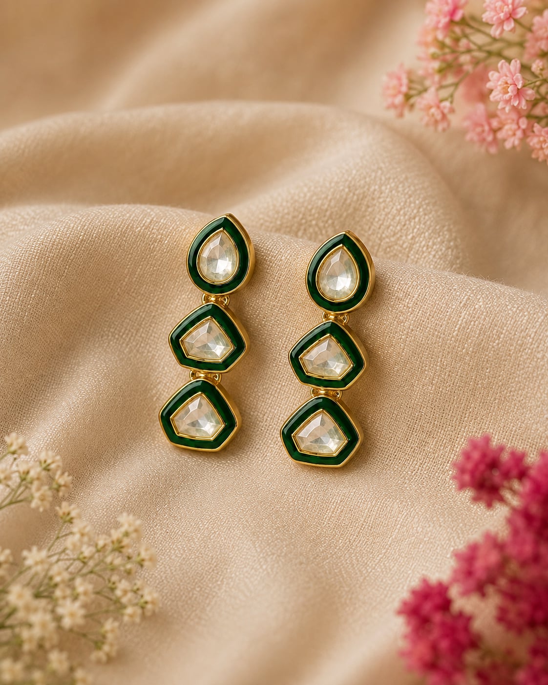 VELQORR emerald green geometric drop earrings with clear stones and gold finish.