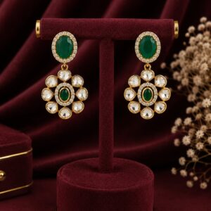 Emerald green floral drop earrings with premium kundan stones and gold-plated finish by VELQORR.