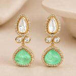 Zivara emerald-green teardrop earrings with sparkling clear stones and gold-plated detailing by VELQORR.