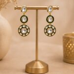 VELQORR emerald green and gold layered circular drop earrings with sparkling clear stones.