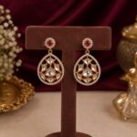 Roselle ruby-toned geometric drop earrings with white crystals and gold-toned detailing by VELQORR.