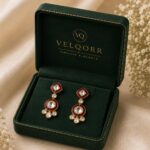 Rubyra red Meenakari Polki drop earrings with clear Polki stones and gold detailing by VELQORR.