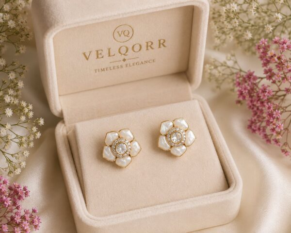 White floral stud earrings with mother-of-pearl inspired petals and sparkling cubic zirconia by VELQORR.