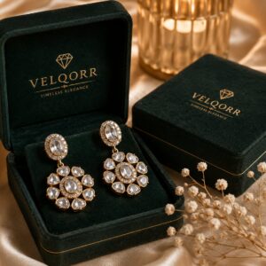 White floral kundan drop earrings with oval stones and premium gold-plated finish by VELQORR.