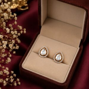 Gold-plated pear-shaped halo stud earrings with premium cubic zirconia by VELQORR.