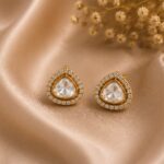 Nyla Crystal Polki Stud Earrings with clear stones and gold detailing by VELQORR.